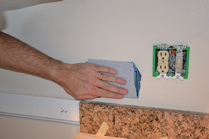 Rough up the backsplash area with sandpaper.